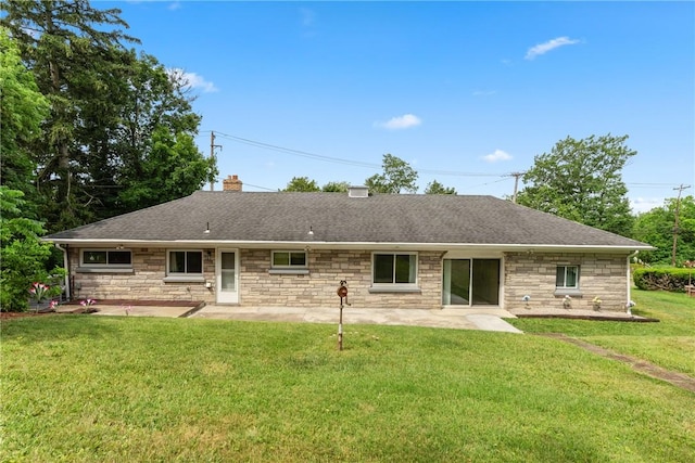 rear view of property with a yard and a patio