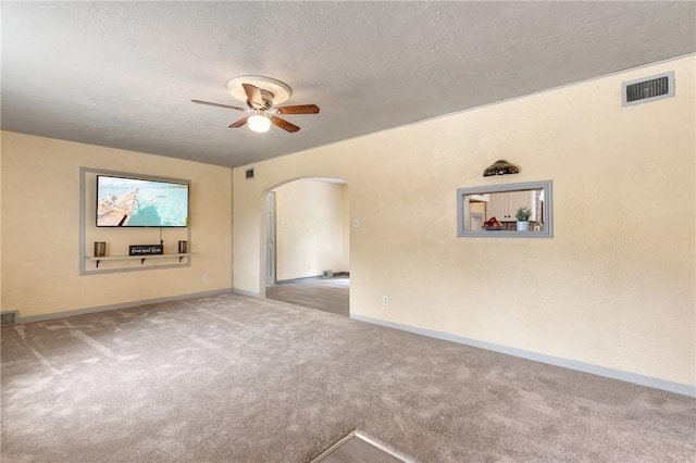 unfurnished living room featuring ceiling fan, light carpet, and a textured ceiling