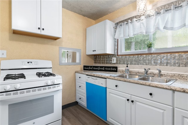 kitchen with dark wood-type flooring, sink, white cabinetry, a textured ceiling, and white appliances