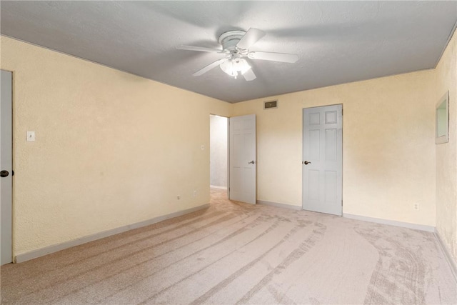 unfurnished bedroom featuring ceiling fan and light colored carpet