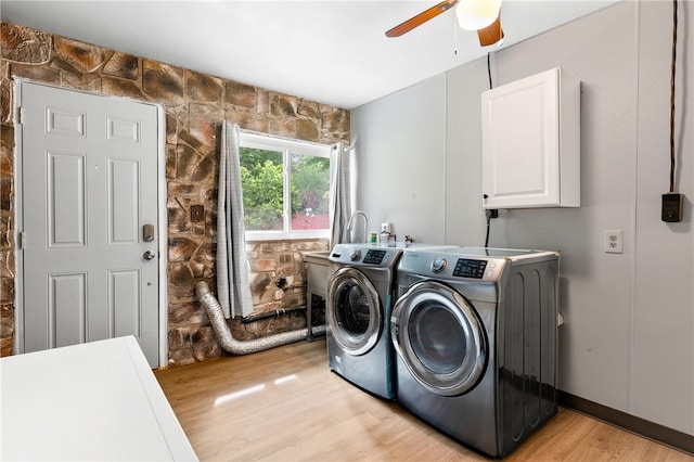 laundry area featuring cabinets, ceiling fan, separate washer and dryer, and light wood-type flooring