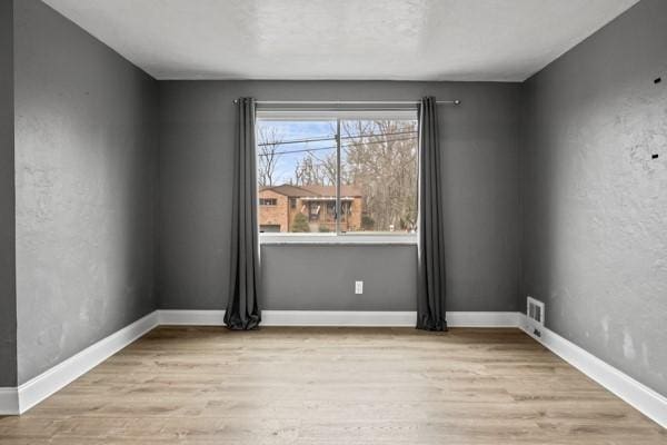 unfurnished room with light hardwood / wood-style floors