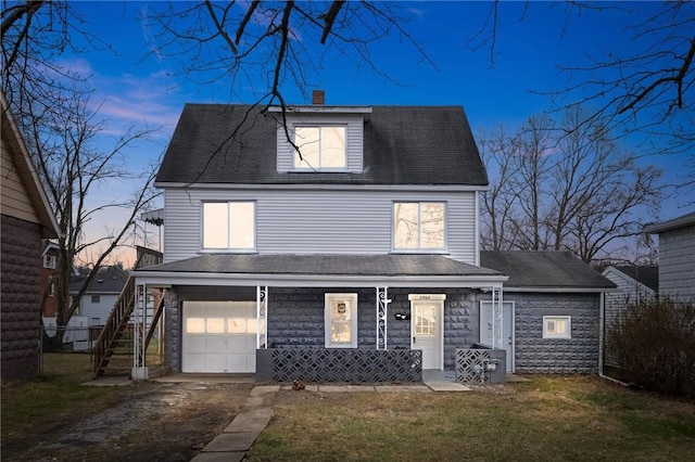 view of front facade with a garage and covered porch