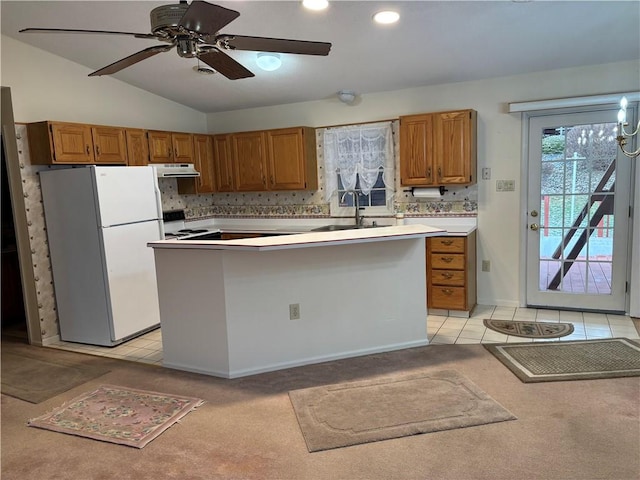 kitchen featuring white refrigerator, sink, electric range oven, and light tile patterned floors