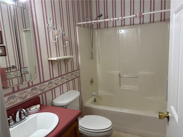 full bathroom featuring vanity, toilet, and washtub / shower combination