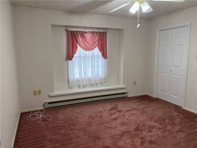 spare room with a baseboard radiator, ceiling fan, and carpet