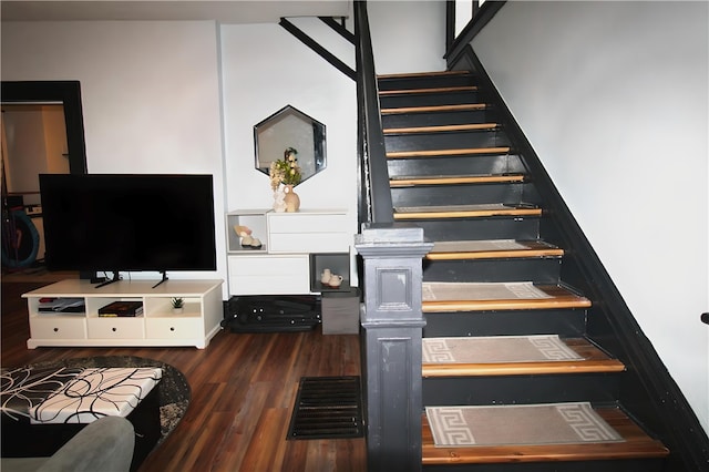 stairs featuring hardwood / wood-style floors