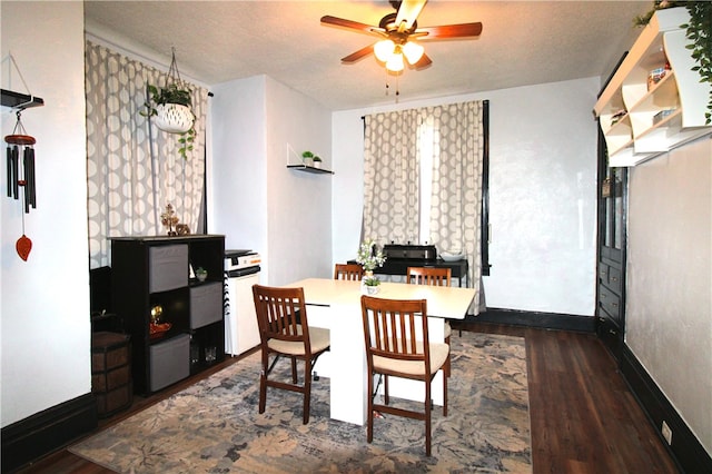 dining space featuring ceiling fan, dark hardwood / wood-style flooring, and a textured ceiling