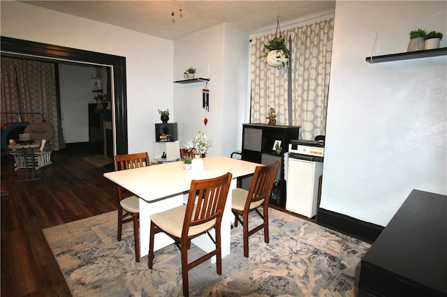 dining area featuring dark hardwood / wood-style floors