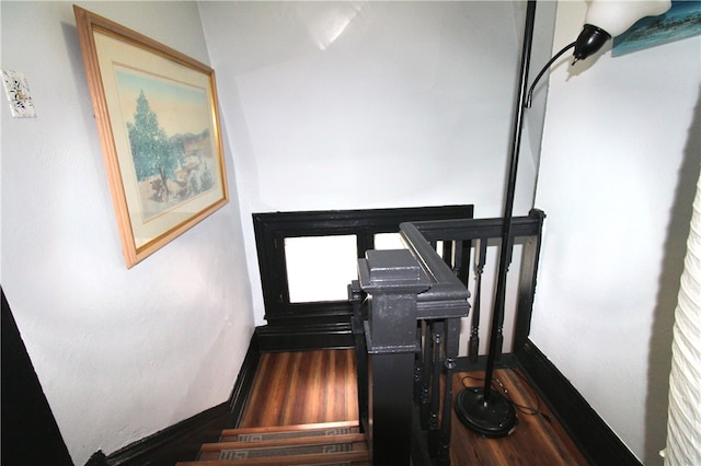 stairway with hardwood / wood-style flooring