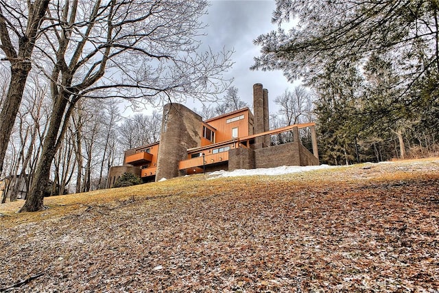 back of property featuring a wooden deck