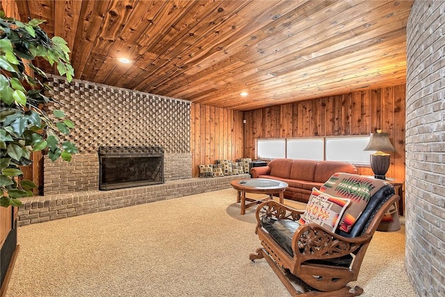 carpeted living room with wood ceiling, wooden walls, and a fireplace