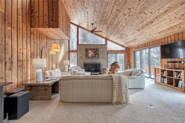 living room featuring carpet, wooden ceiling, wooden walls, and a fireplace