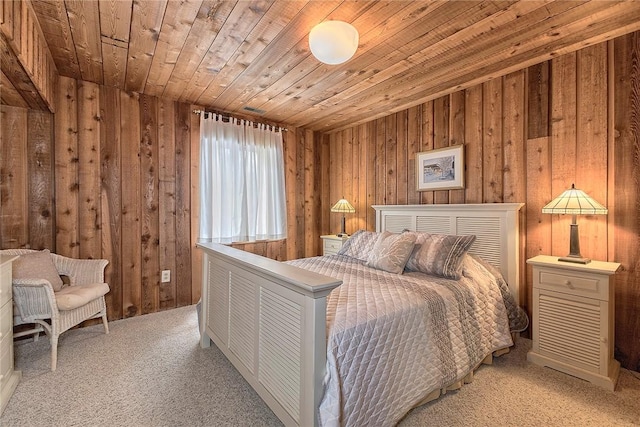 carpeted bedroom featuring wood ceiling and wooden walls