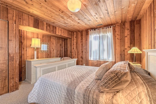 bedroom with carpet floors, wooden ceiling, and wooden walls