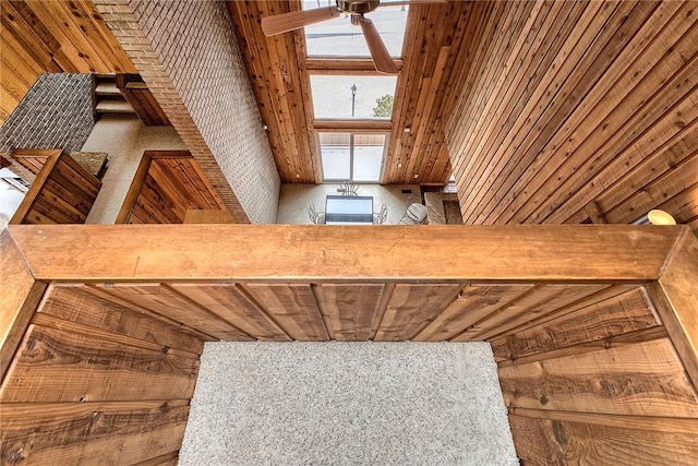 interior space with wooden walls and ceiling fan