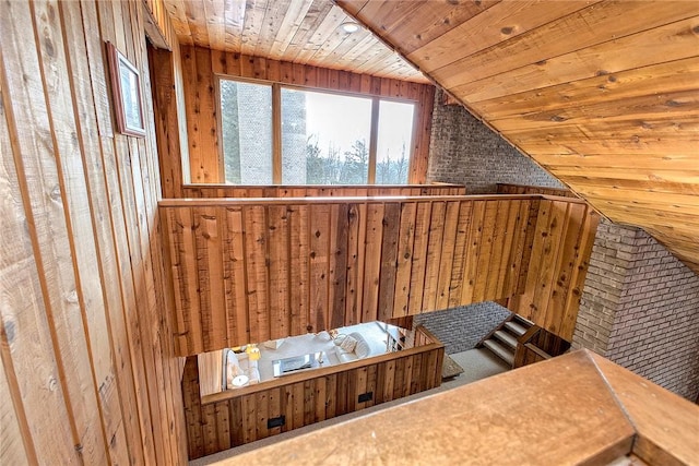 additional living space featuring wood walls, vaulted ceiling, and wooden ceiling