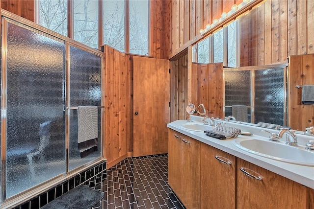 173 Alpine Heights Rd, Saltlick Twp, PA 15622 - bathroom with brick floor, double vanity, wood walls, and a sink