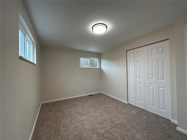 unfurnished bedroom with a closet and carpet