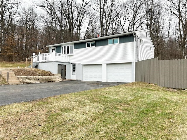 view of front property with a garage, a deck, and a front yard