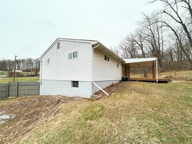 view of property exterior with a yard and central AC