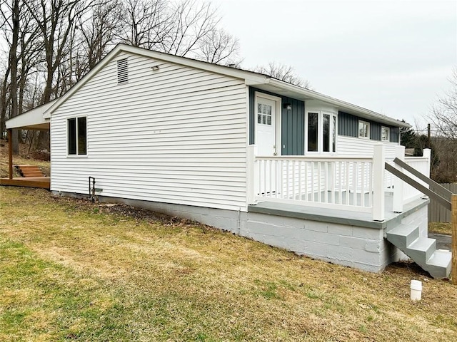 view of home's exterior with a wooden deck and a yard