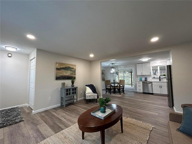 living room with hardwood / wood-style floors and sink