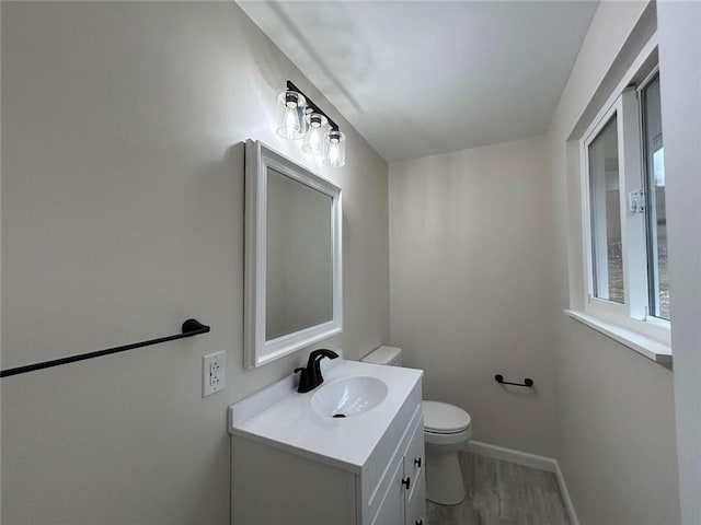 bathroom featuring vanity, hardwood / wood-style floors, and toilet