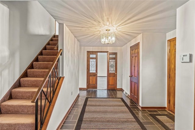 entryway with a chandelier