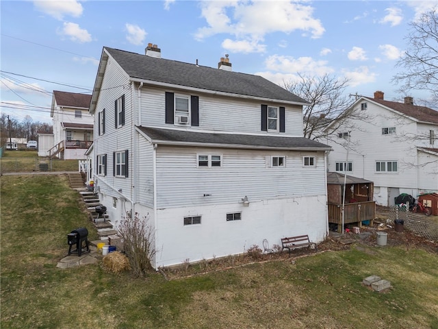 back of property featuring cooling unit and a yard