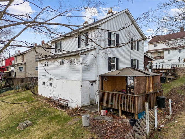 back of house with a gazebo and a yard