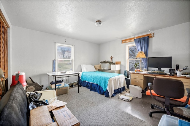 carpeted bedroom featuring multiple windows, a closet, and a textured ceiling