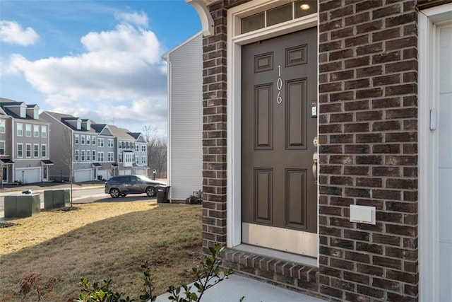 doorway to property featuring a yard