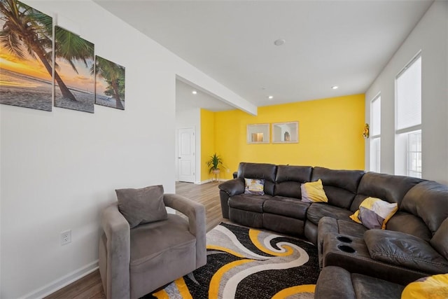 living room with dark hardwood / wood-style floors and beamed ceiling