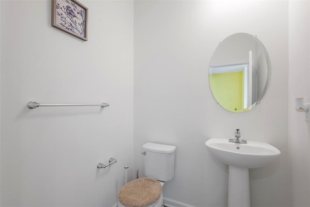 bathroom featuring sink and toilet