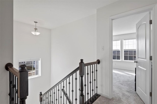 hall featuring light colored carpet