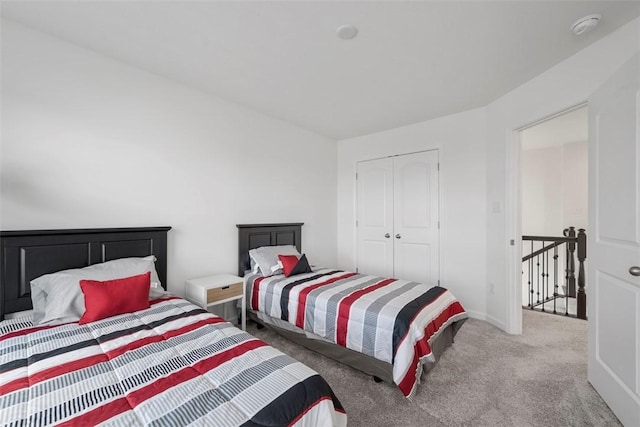 bedroom with a closet and light carpet