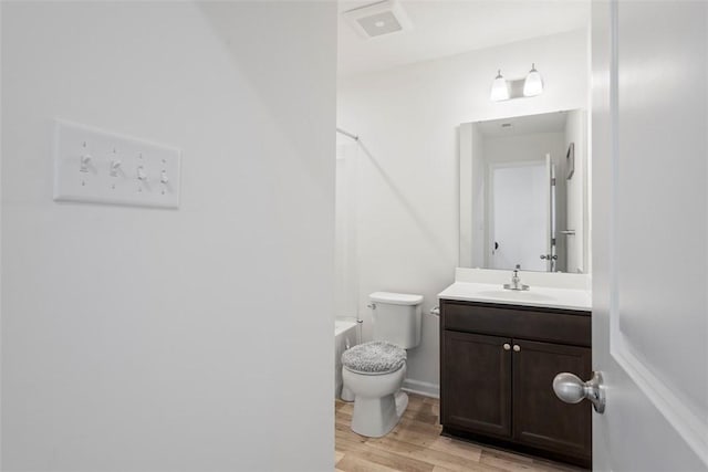 bathroom featuring hardwood / wood-style flooring, vanity, and toilet