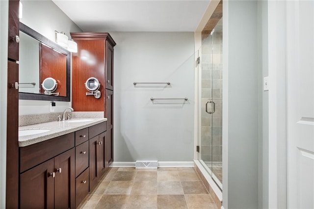 bathroom with vanity, tile patterned floors, and walk in shower