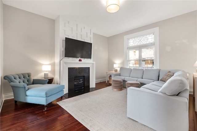 living room with dark hardwood / wood-style floors and a fireplace