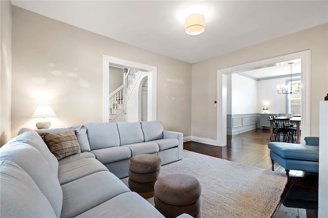 living room with an inviting chandelier and dark hardwood / wood-style flooring