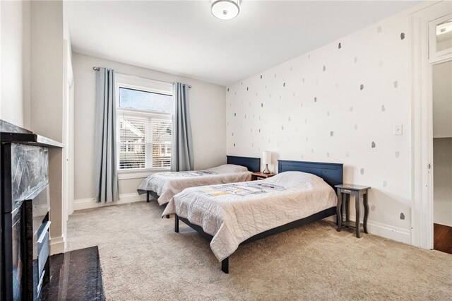 carpeted bedroom with a fireplace