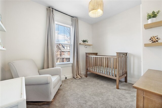 carpeted bedroom with a crib
