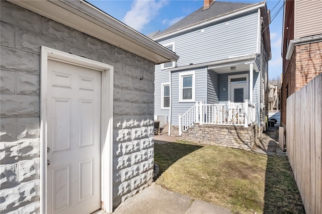 property entrance featuring a yard