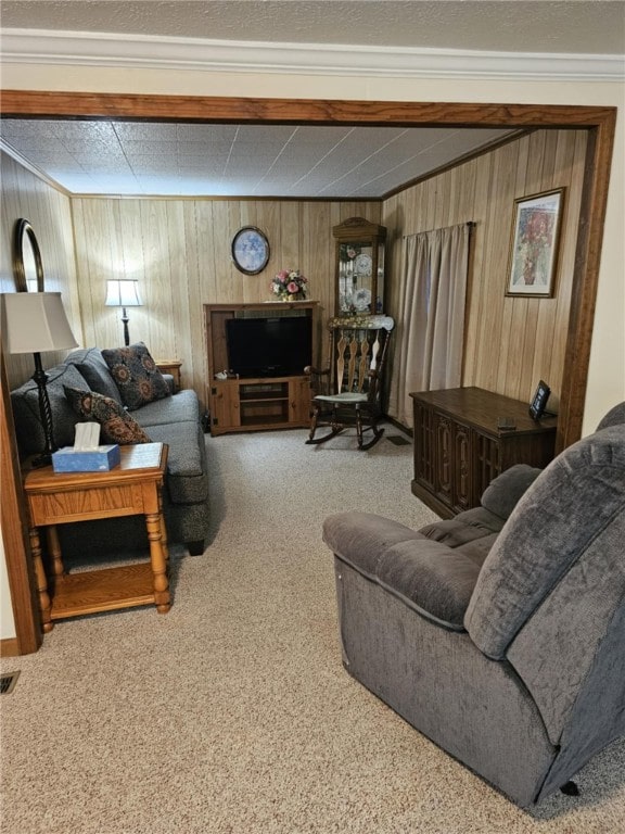 living room featuring ornamental molding, wooden walls, and carpet floors