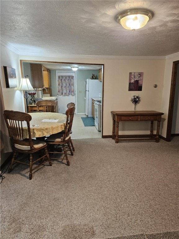 dining space with light carpet, ornamental molding, and a textured ceiling