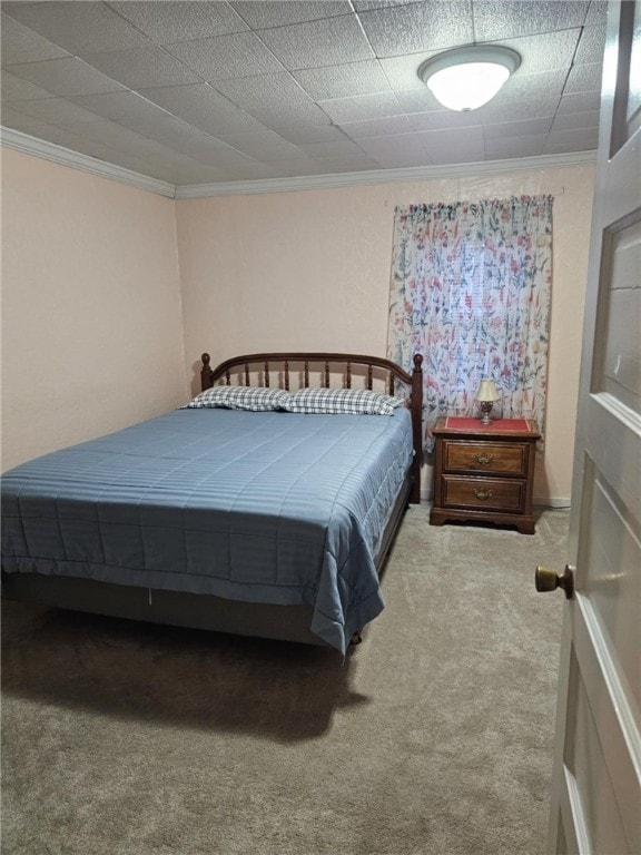 bedroom featuring ornamental molding and carpet