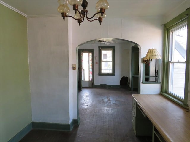 foyer featuring a notable chandelier, crown molding, and dark hardwood / wood-style floors