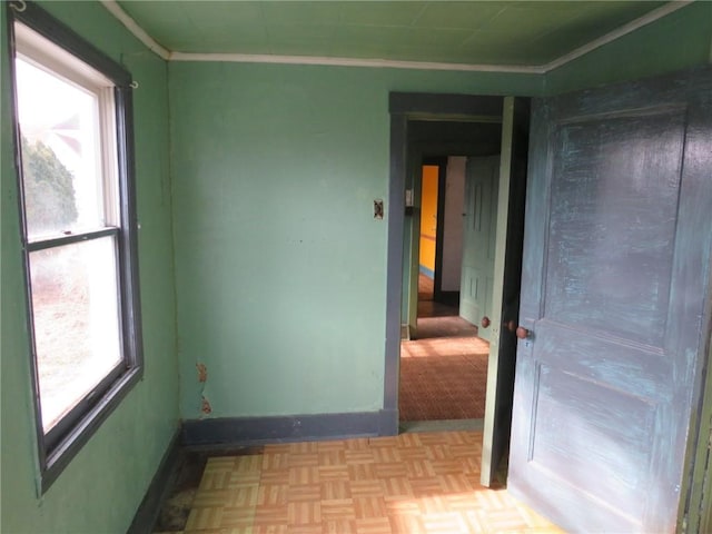 empty room with ornamental molding and light parquet flooring