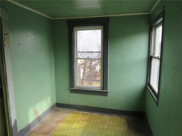 spare room with light parquet floors and plenty of natural light